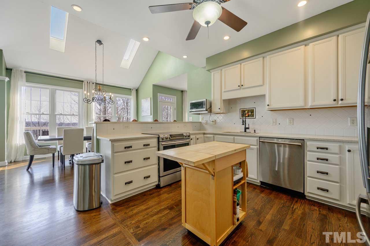 7001 New Sharon Church Road Rougemont, NC 27572 - Photo 6 of 52 a kitchen with a stove window and cabinets