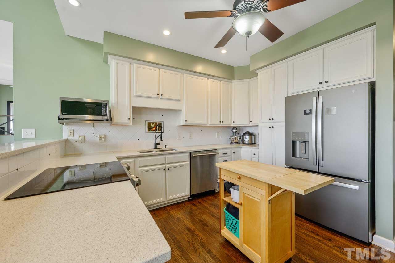 7001 New Sharon Church Road Rougemont, NC 27572 - Photo 7 of 52 a kitchen with a sink a stove and refrigerator