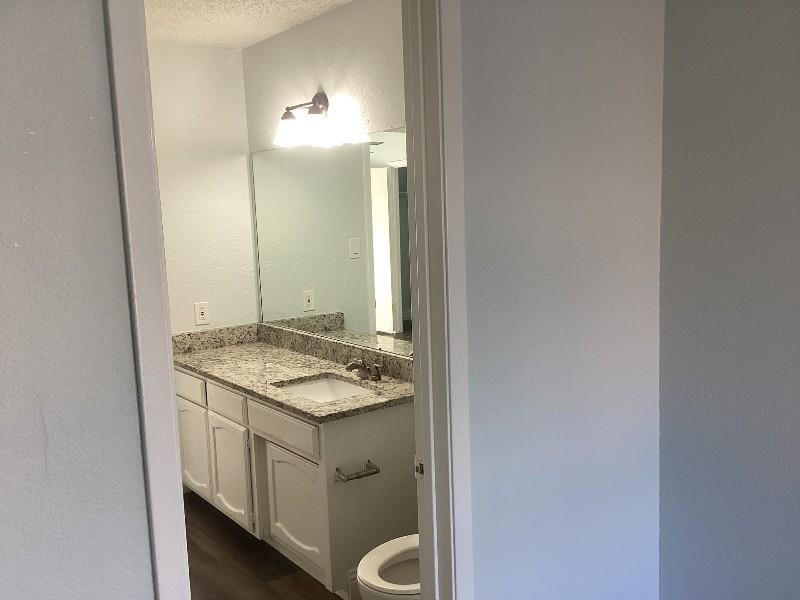 7512 Chapin Road Fort Worth, TX 76116 - Photo 13 of 25 a bathroom with a granite countertop sink and a mirror