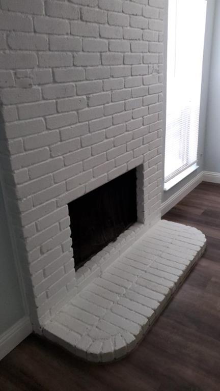 7512 Chapin Road Fort Worth, TX 76116 - Photo 5 of 25 a room with a wooden floor and a fireplace