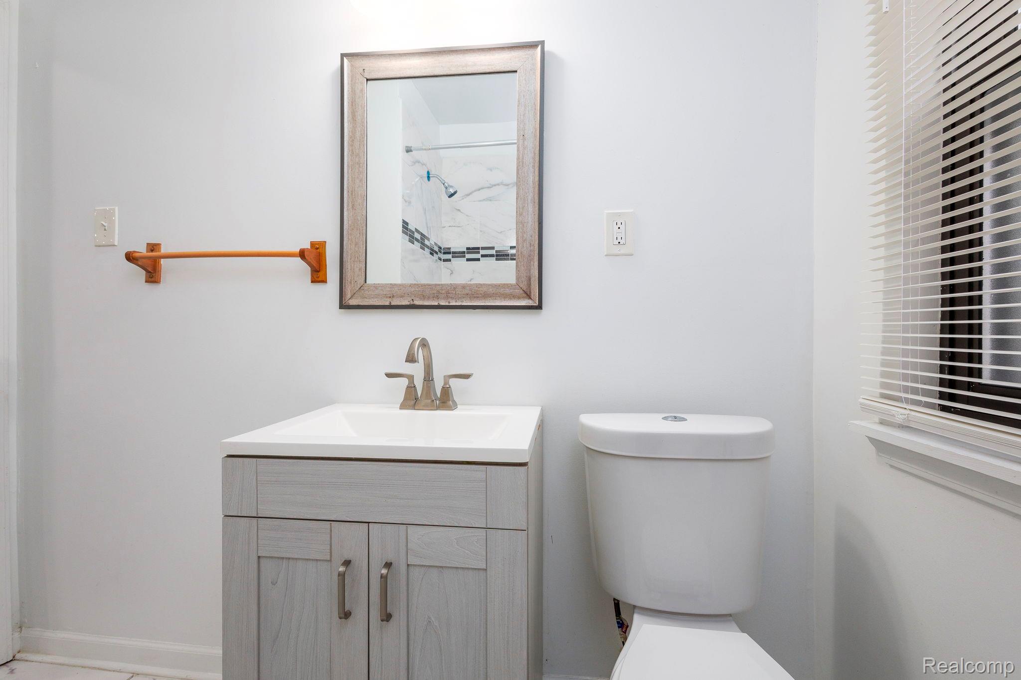 3974 Devonshire Road Detroit, MI 48224 - Photo 14 of 15 Contemporary vanity with an integrated sink and light grey wood-look cabinetry