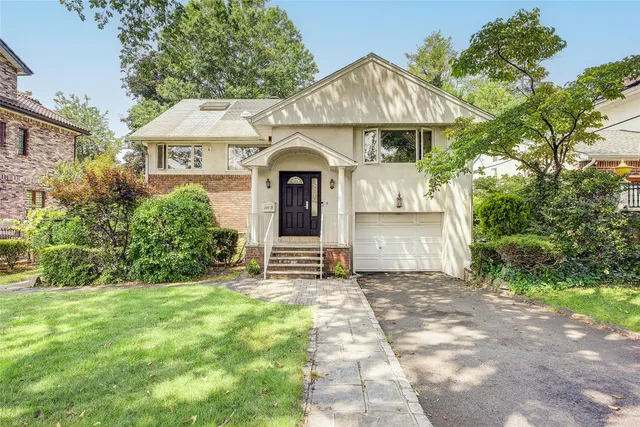 a front view of a house with a garden