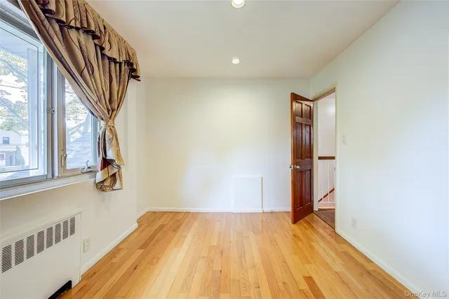 a view of a room with wooden floor and wardrobe