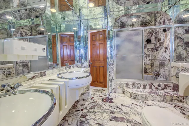 a bathroom with a tub sink and mirror