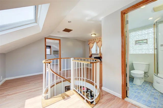 a view of a hallway with a white walls and stairs