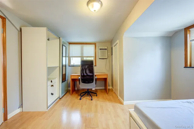 a bedroom with a bed and a desk