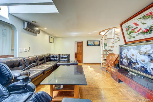 a living room with furniture and wall paintings