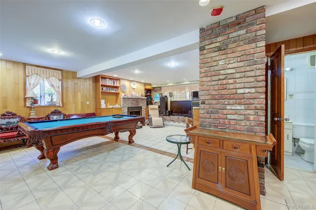 a room with furniture pool table and windows