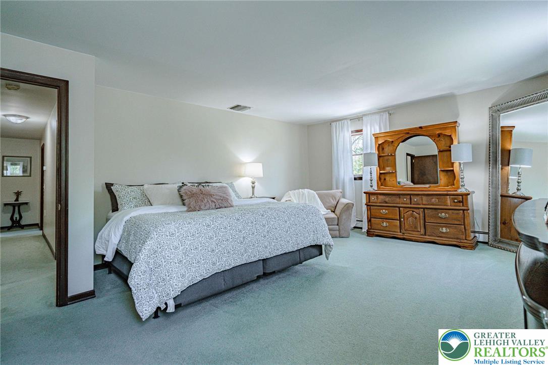 3857 Friedens Road Slatington, PA 18080 - Photo 38 of 75 This spacious primary bedroom offers plush carpeting, abundant natural light, and a dedicated sitting area.