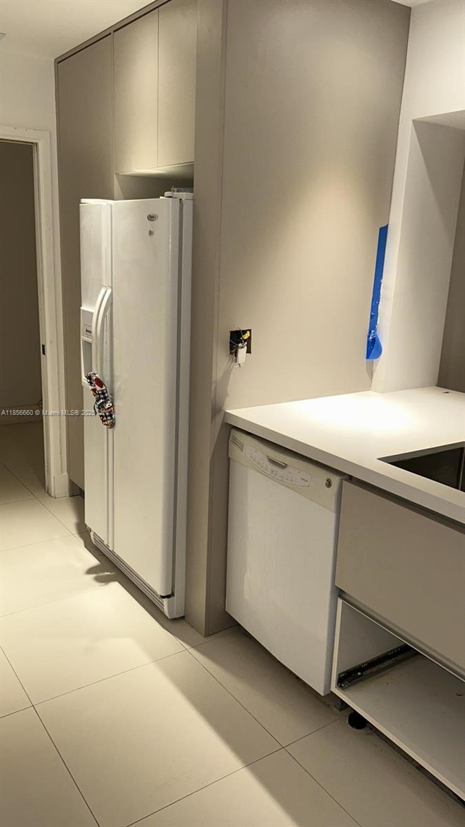 251 Crandon Boulevard, Unit 929 Key Biscayne, FL 33149 - Photo 12 of 26 a utility room with cabinets