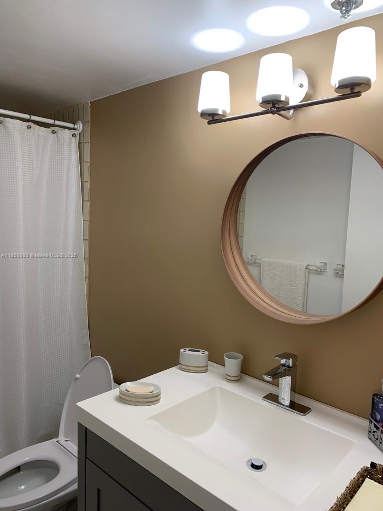 251 Crandon Boulevard, Unit 929 Key Biscayne, FL 33149 - Photo 15 of 26 a bathroom with a sink and a mirror