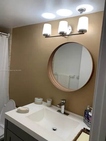 a bedroom with a bed and a lamp