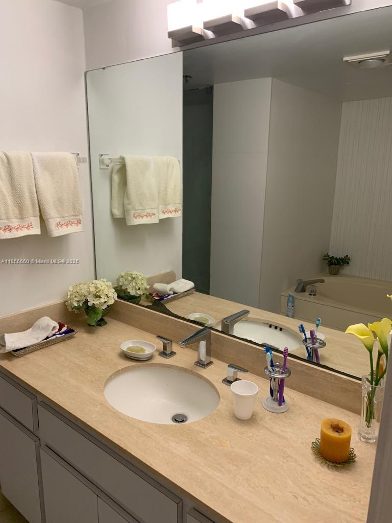 251 Crandon Boulevard, Unit 929 Key Biscayne, FL 33149 - Photo 26 of 26 a bathroom with a sink and a mirror