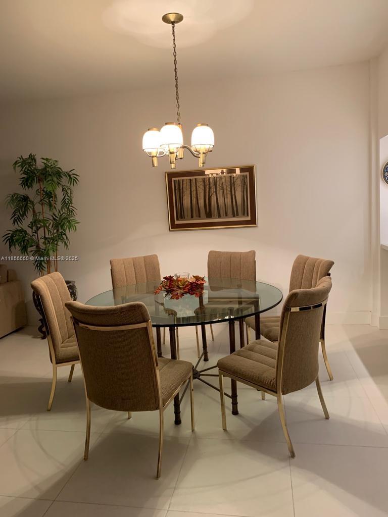 251 Crandon Boulevard, Unit 929 Key Biscayne, FL 33149 - Photo 7 of 26 a view of a dining room with furniture and wooden floor