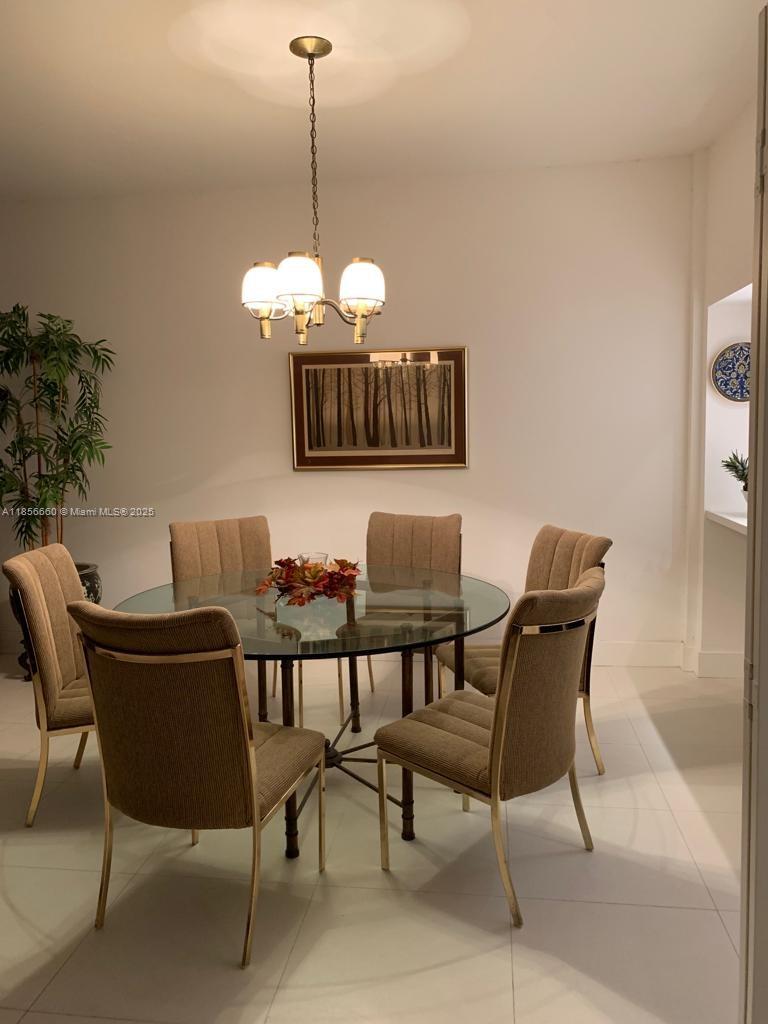 251 Crandon Boulevard, Unit 929 Key Biscayne, FL 33149 - Photo 8 of 26 a view of a dining room with furniture