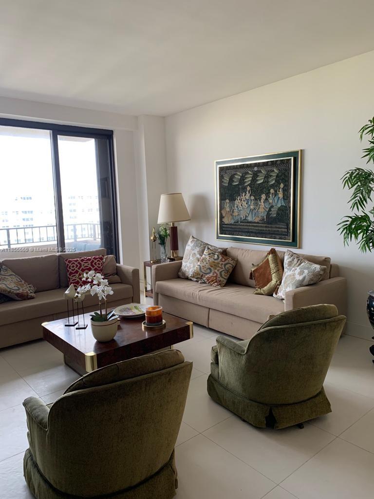 251 Crandon Boulevard, Unit 929 Key Biscayne, FL 33149 - Photo 9 of 26 a living room with furniture and a large window