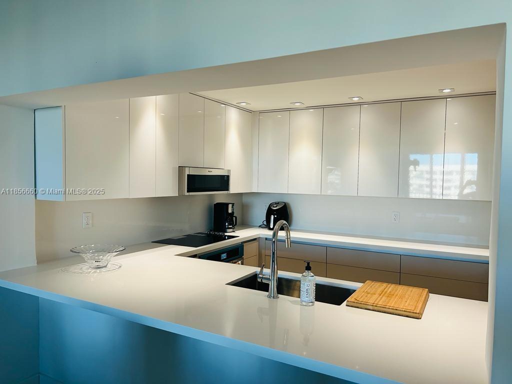 251 Crandon Boulevard, Unit 929 Key Biscayne, FL 33149 - Photo 10 of 26 a kitchen with a sink and a view of living room