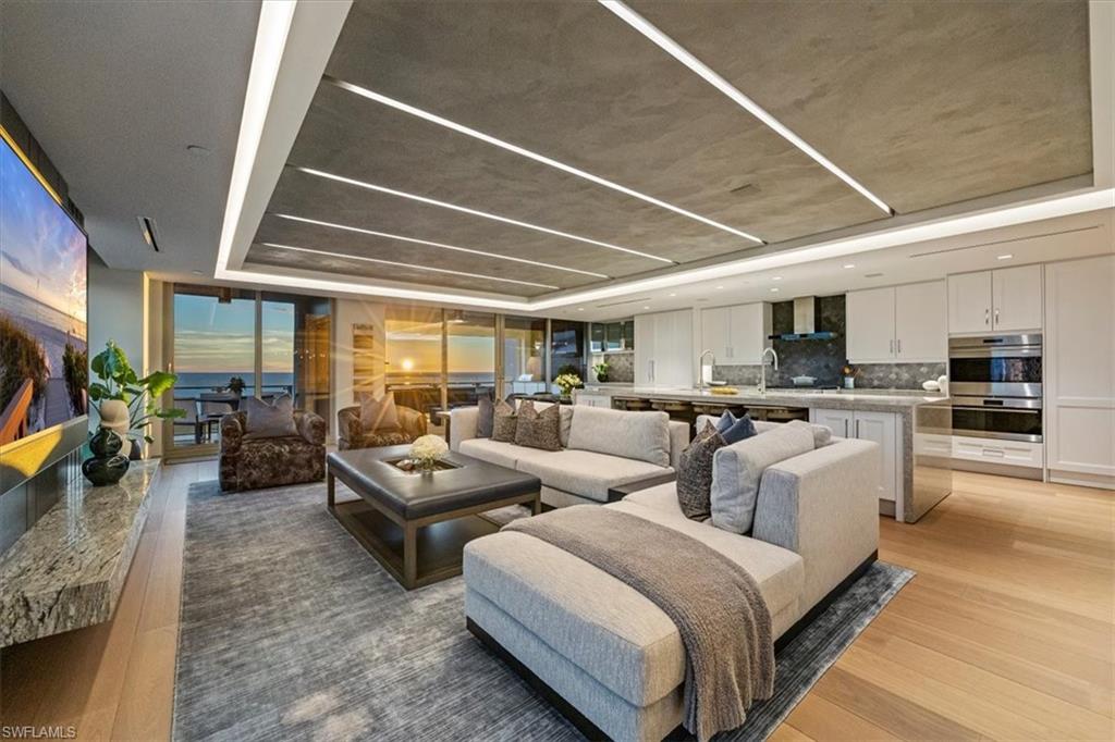 6897 Grenadier Boulevard, Unit 1701 Naples, FL 34108 - Photo 1 of 50 a living room with furniture and a large window