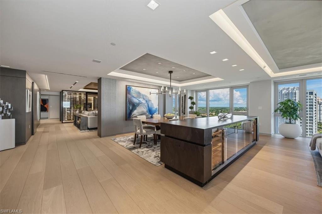 6897 Grenadier Boulevard, Unit 1701 Naples, FL 34108 - Photo 12 of 50 a living room with furniture and a large window