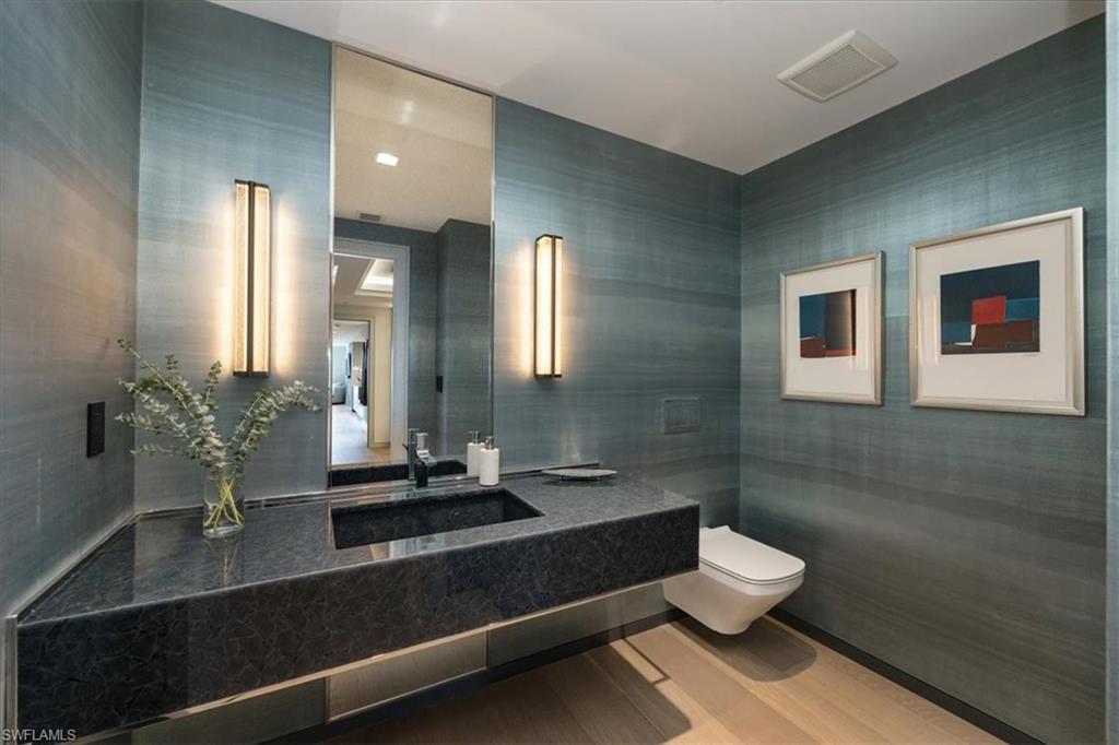 6897 Grenadier Boulevard, Unit 1701 Naples, FL 34108 - Photo 16 of 50 a bathroom with a sink and a mirror