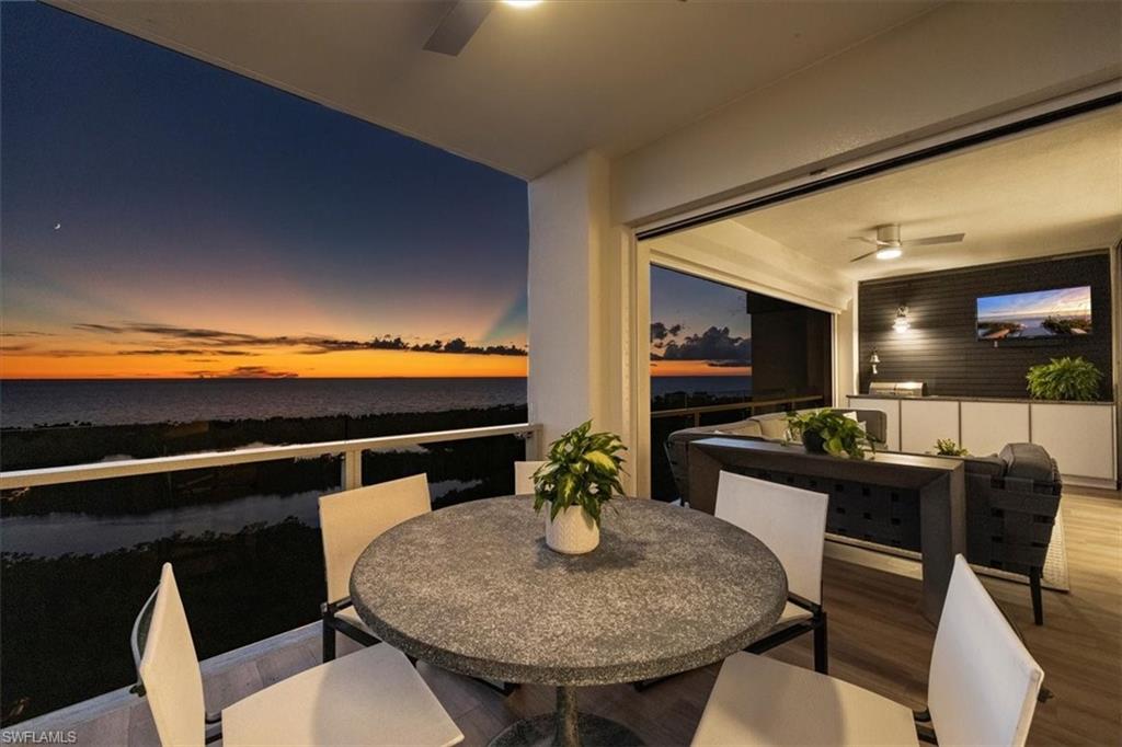 6897 Grenadier Boulevard, Unit 1701 Naples, FL 34108 - Photo 17 of 50 a kitchen with a table and chairs in it