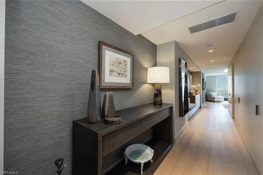 6897 Grenadier Boulevard, Unit 1701 Naples, FL 34108 - Photo 18 of 50 a view of a hallway with wooden floor