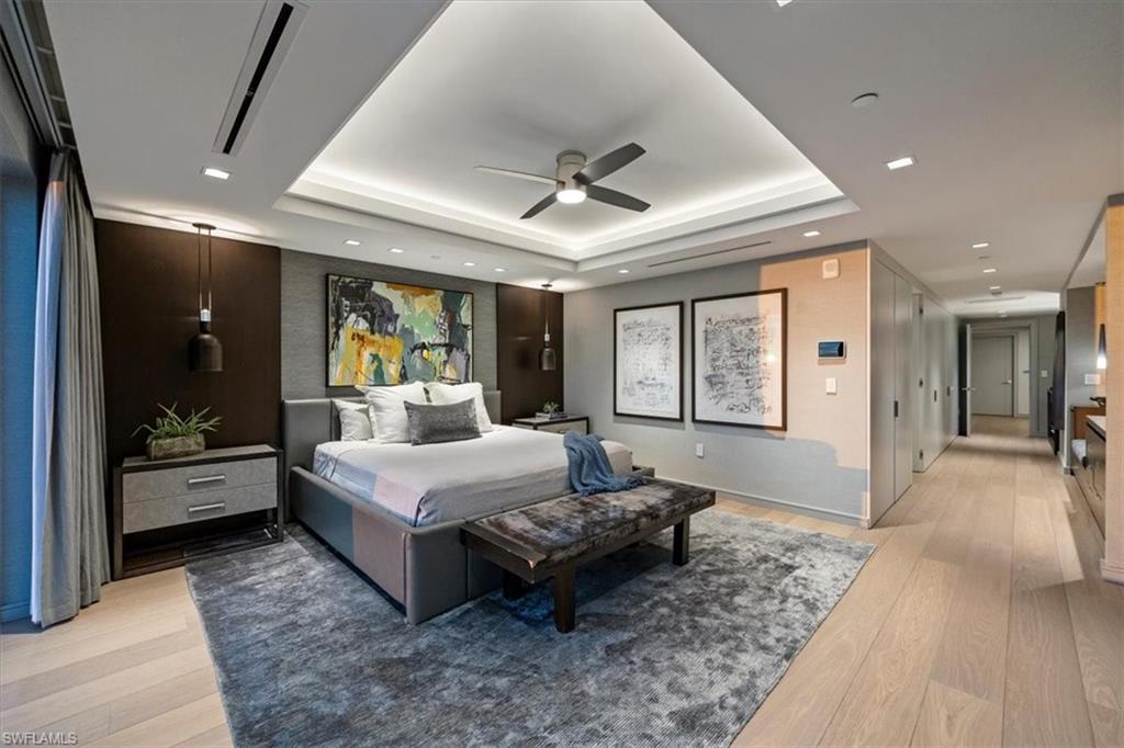 6897 Grenadier Boulevard, Unit 1701 Naples, FL 34108 - Photo 20 of 50 a spacious bedroom with a large bed and a couch