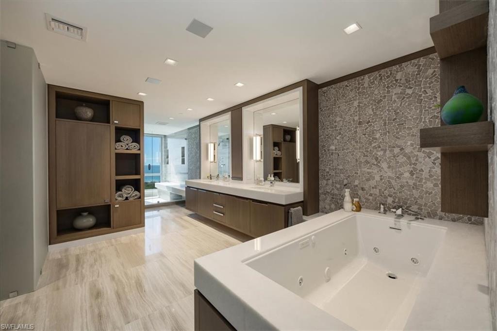 6897 Grenadier Boulevard, Unit 1701 Naples, FL 34108 - Photo 21 of 50 a bathroom with a bathtub and a sink