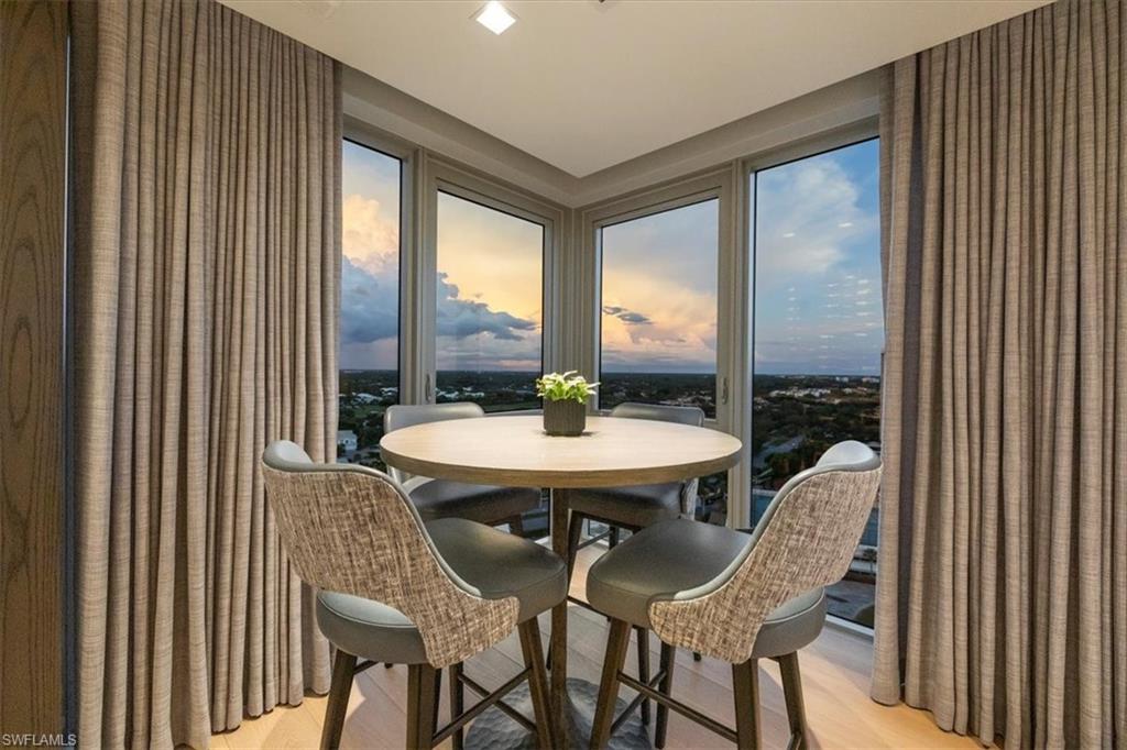 6897 Grenadier Boulevard, Unit 1701 Naples, FL 34108 - Photo 25 of 50 a view of a dining room with furniture window and outside view