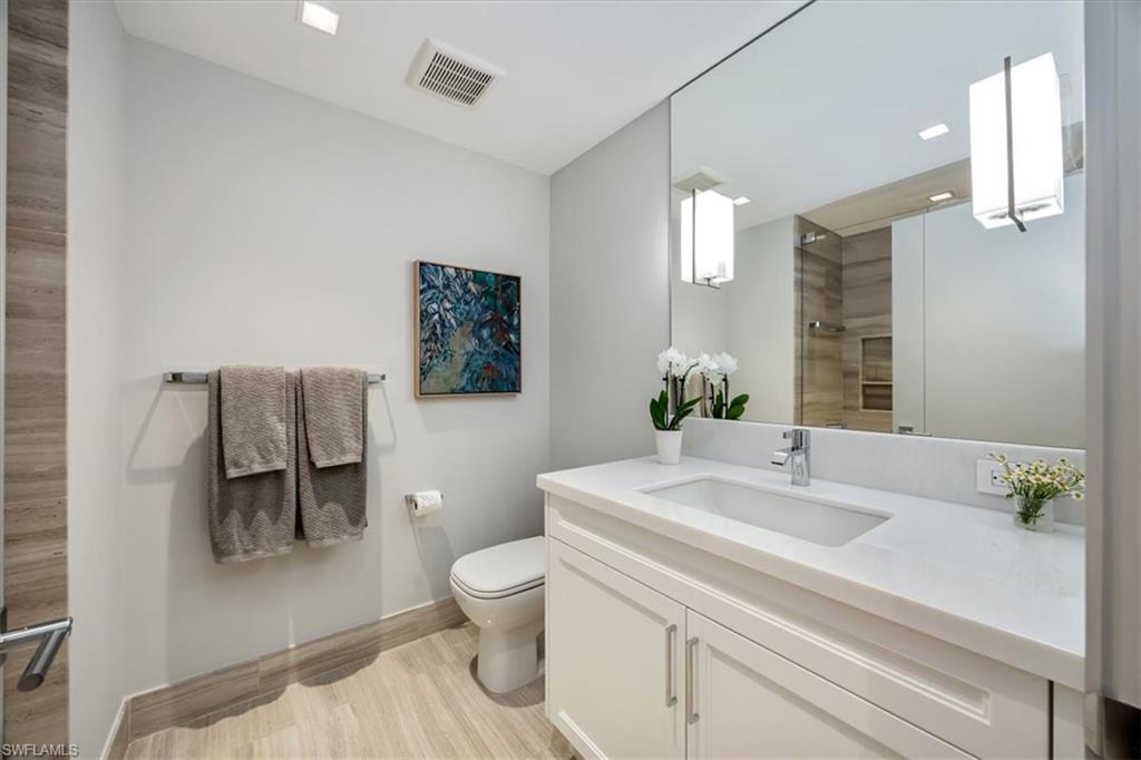 6897 Grenadier Boulevard, Unit 1701 Naples, FL 34108 - Photo 32 of 50 a bathroom with a sink toilet and shower