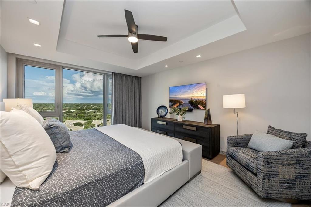 6897 Grenadier Boulevard, Unit 1701 Naples, FL 34108 - Photo 33 of 50 a bed room with a bed window and a couch