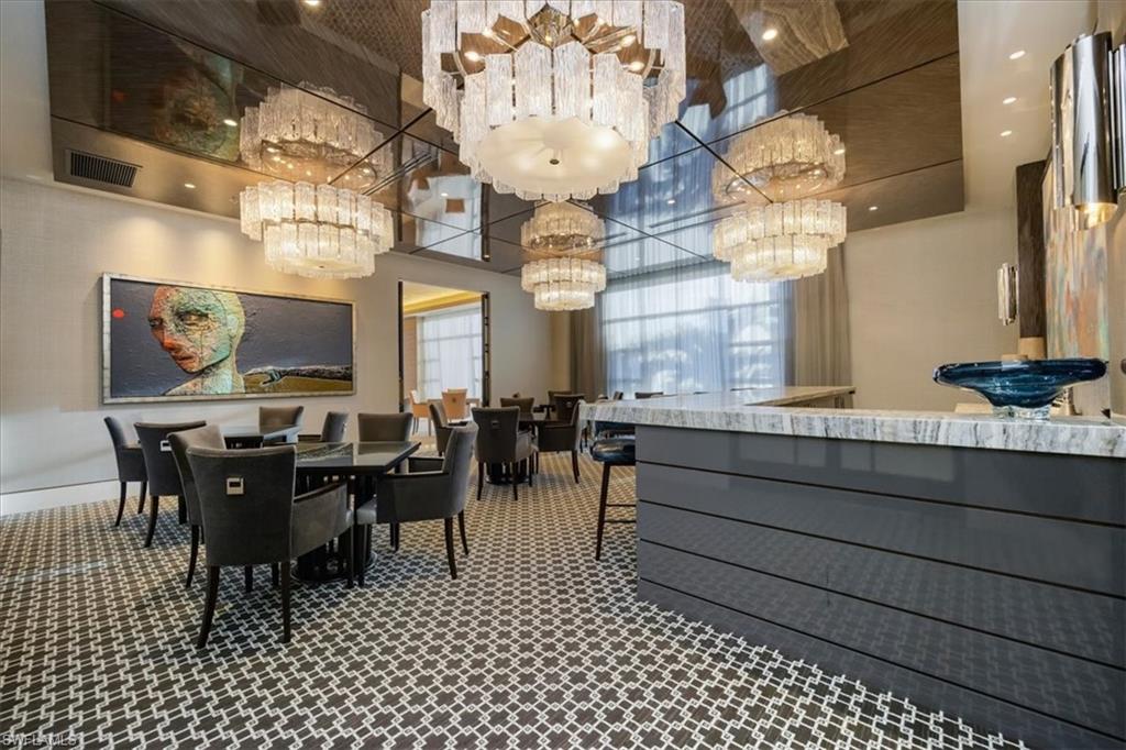 6897 Grenadier Boulevard, Unit 1701 Naples, FL 34108 - Photo 40 of 50 a view of a dining room with furniture
