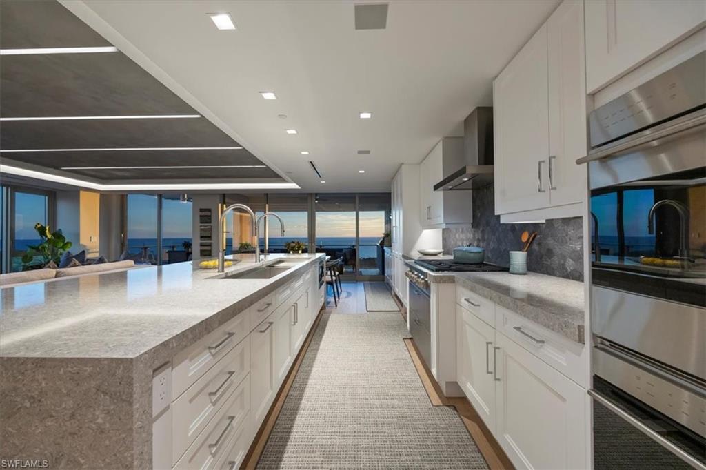 6897 Grenadier Boulevard, Unit 1701 Naples, FL 34108 - Photo 4 of 50 a large kitchen with stainless steel appliances lots of counter space and a sink