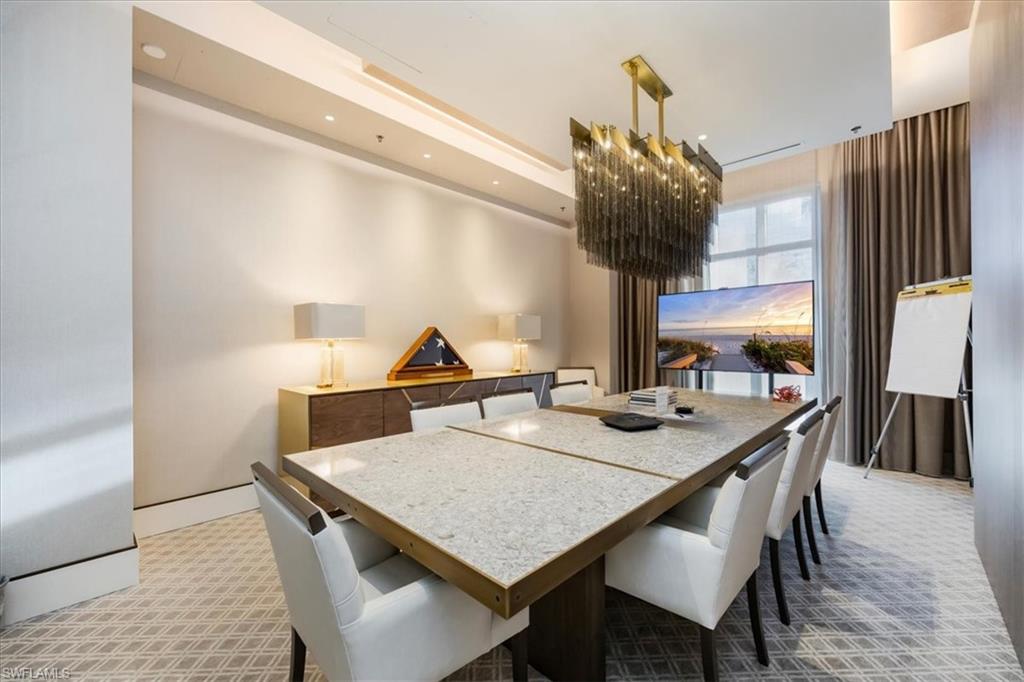 6897 Grenadier Boulevard, Unit 1701 Naples, FL 34108 - Photo 45 of 50 a view of a dining table chairs and chandelier