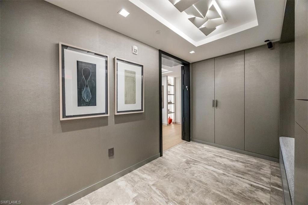 6897 Grenadier Boulevard, Unit 1701 Naples, FL 34108 - Photo 6 of 50 a bathroom with a mirror and a shower