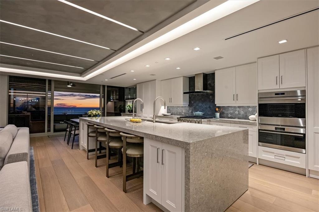 6897 Grenadier Boulevard, Unit 1701 Naples, FL 34108 - Photo 9 of 50 a kitchen with stainless steel appliances granite countertop a stove and a refrigerator