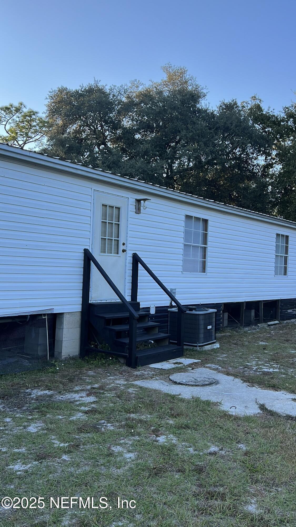 85182 Lonnie Crews Road Fernandina Beach, FL 32034 - Photo 13 of 15 a front view of a house with a yard
