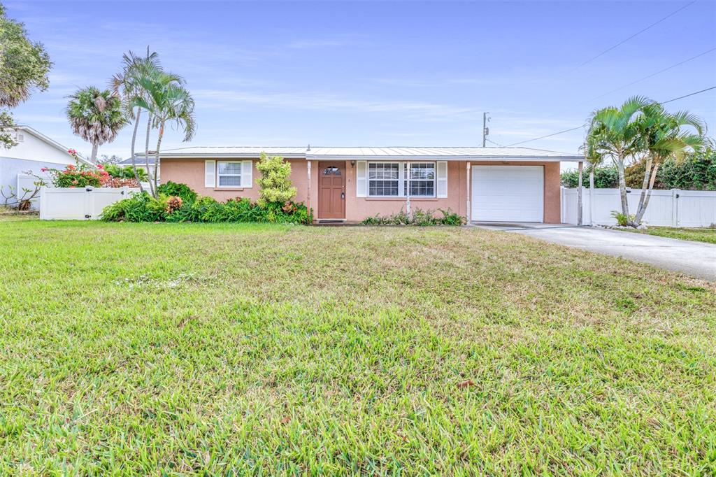 655 Carmel Road Venice, FL 34293 - Photo 1 of 1 a front view of a house with a yard and garage
