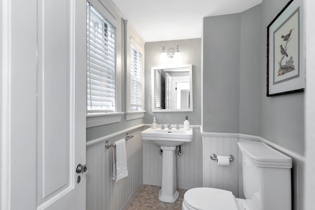 505 Essex Street Hamilton, MA 01982 - Photo 12 of 37 a bathroom with a toilet sink and mirror