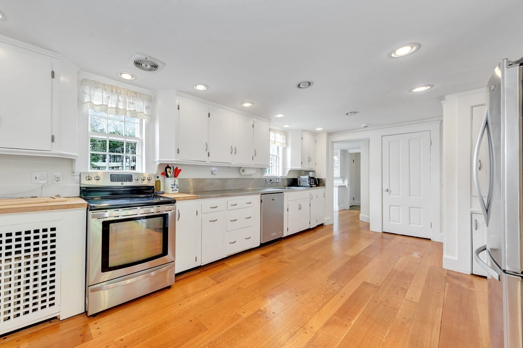 505 Essex Street Hamilton, MA 01982 - Photo 14 of 37 a kitchen with stainless steel appliances granite countertop a stove a sink and white cabinets
