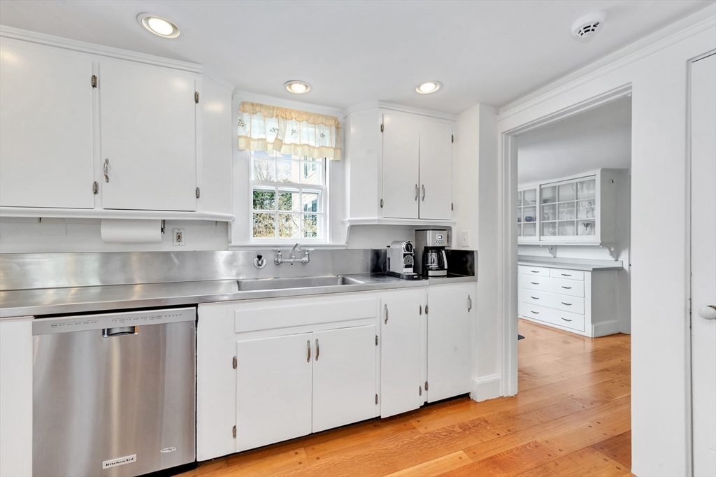 505 Essex Street Hamilton, MA 01982 - Photo 16 of 37 a kitchen with stainless steel appliances granite countertop a sink a stove a refrigerator and white cabinets