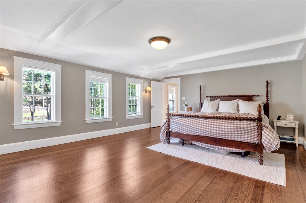 505 Essex Street Hamilton, MA 01982 - Photo 20 of 37 a spacious bedroom with a bed and a window