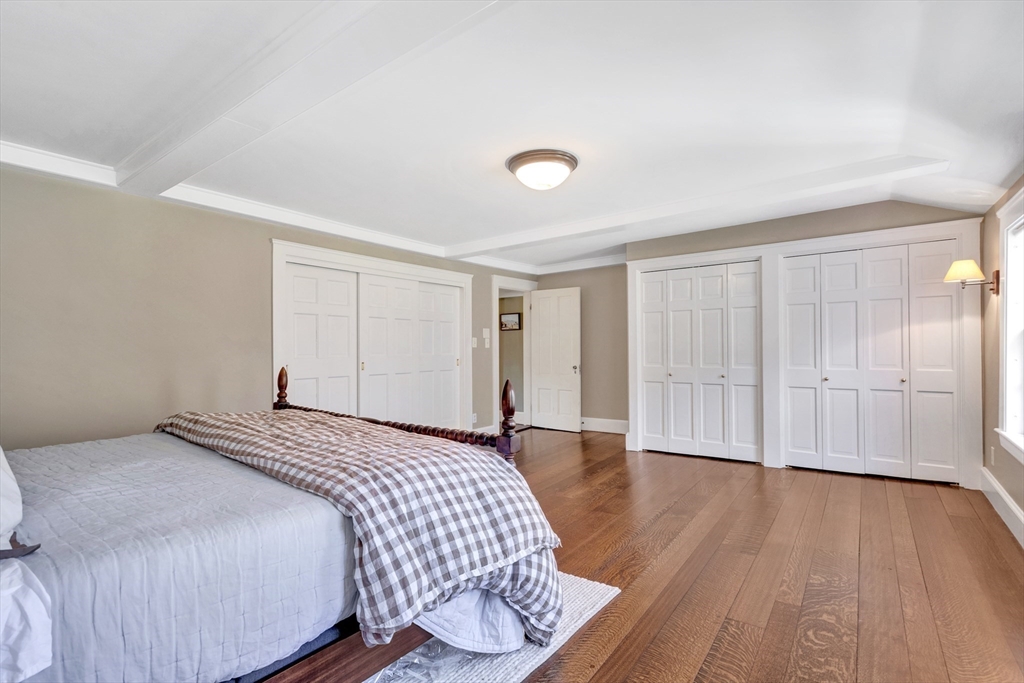 505 Essex Street Hamilton, MA 01982 - Photo 21 of 37 a bedroom with a bed and wooden floor
