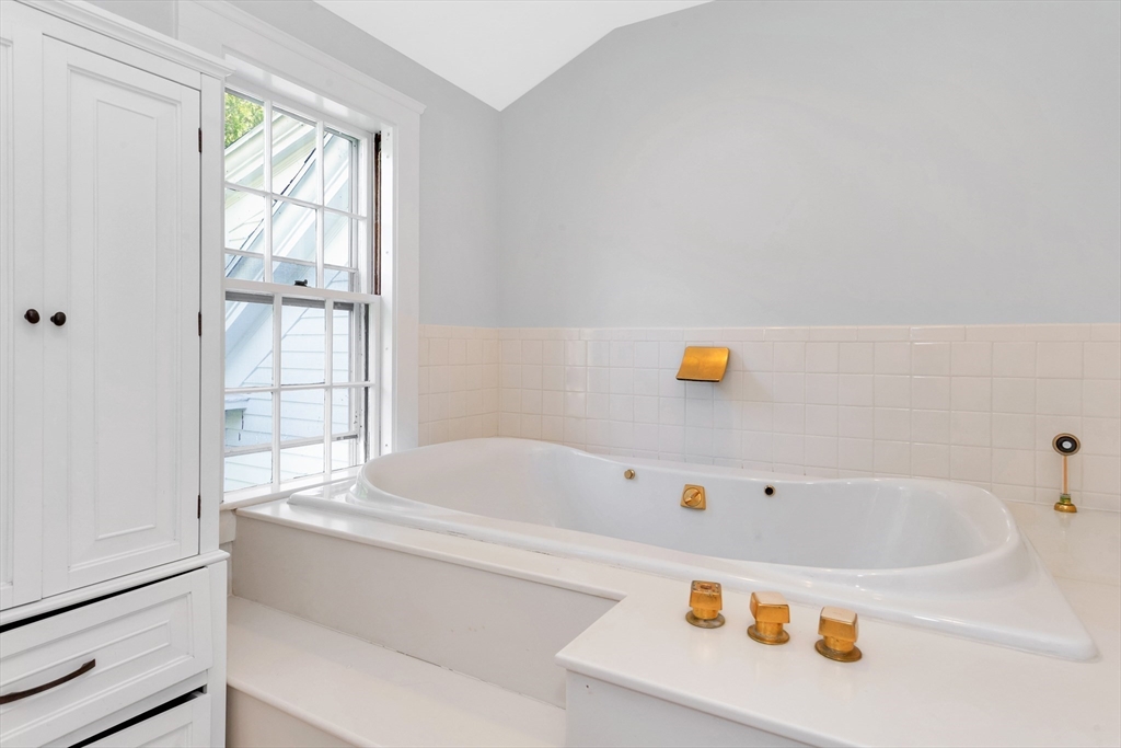 505 Essex Street Hamilton, MA 01982 - Photo 23 of 37 a bathroom with a bathtub and next to a window
