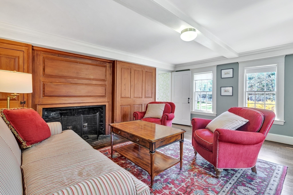 505 Essex Street Hamilton, MA 01982 - Photo 24 of 37 a living room with furniture a flat screen tv and a fireplace
