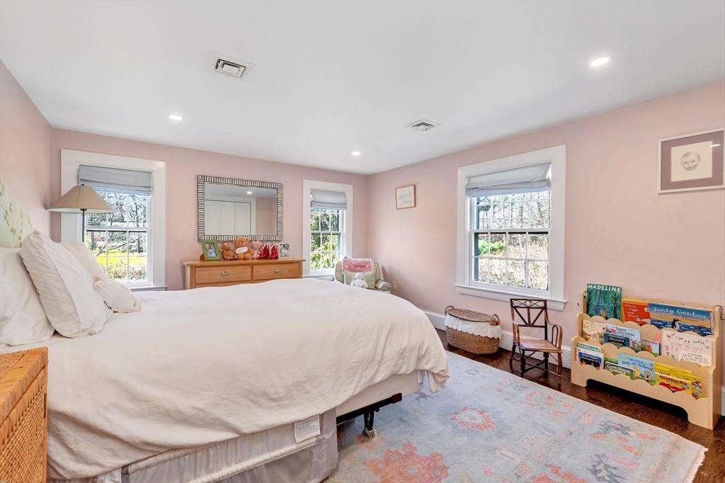 505 Essex Street Hamilton, MA 01982 - Photo 27 of 37 a bedroom with a bed a couch and a window