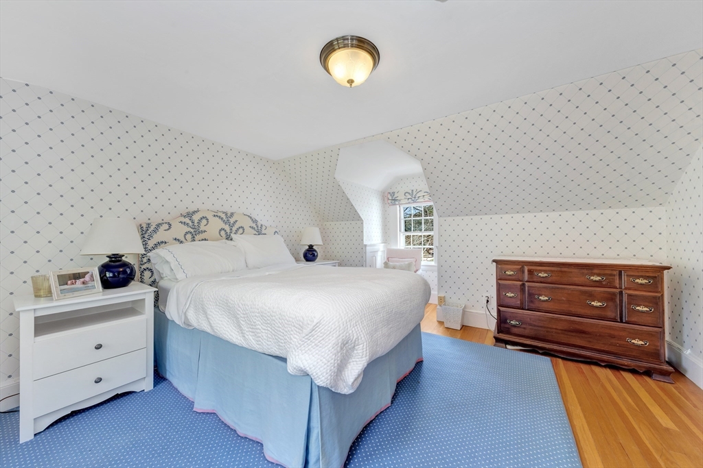 505 Essex Street Hamilton, MA 01982 - Photo 28 of 37 a bedroom with a bed and a dresser