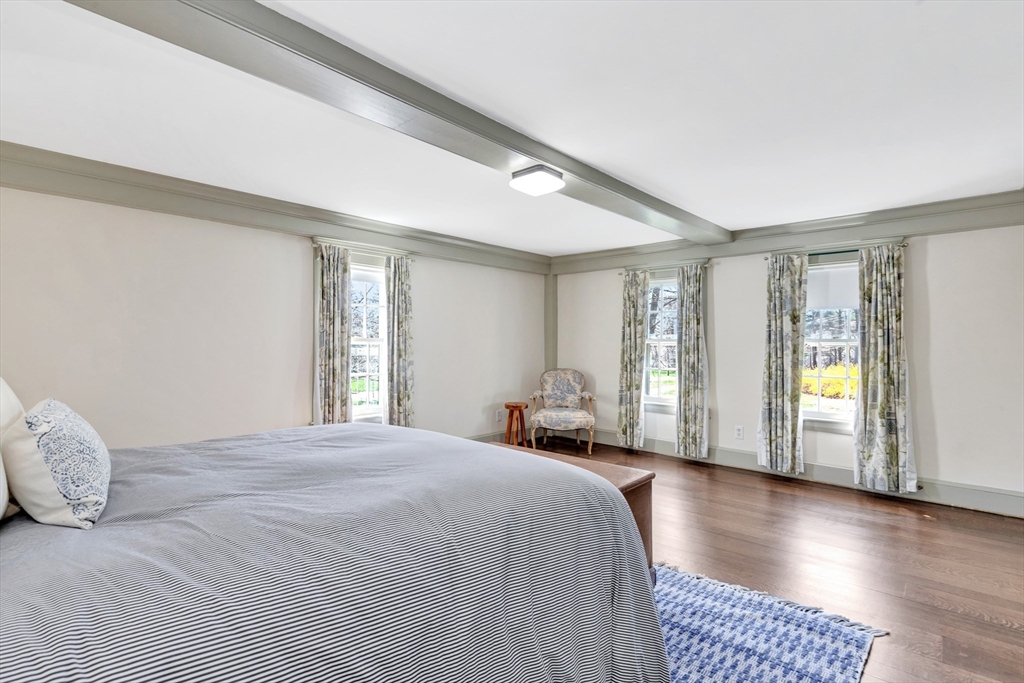 505 Essex Street Hamilton, MA 01982 - Photo 29 of 37 a spacious bedroom with a bed and wooden floor