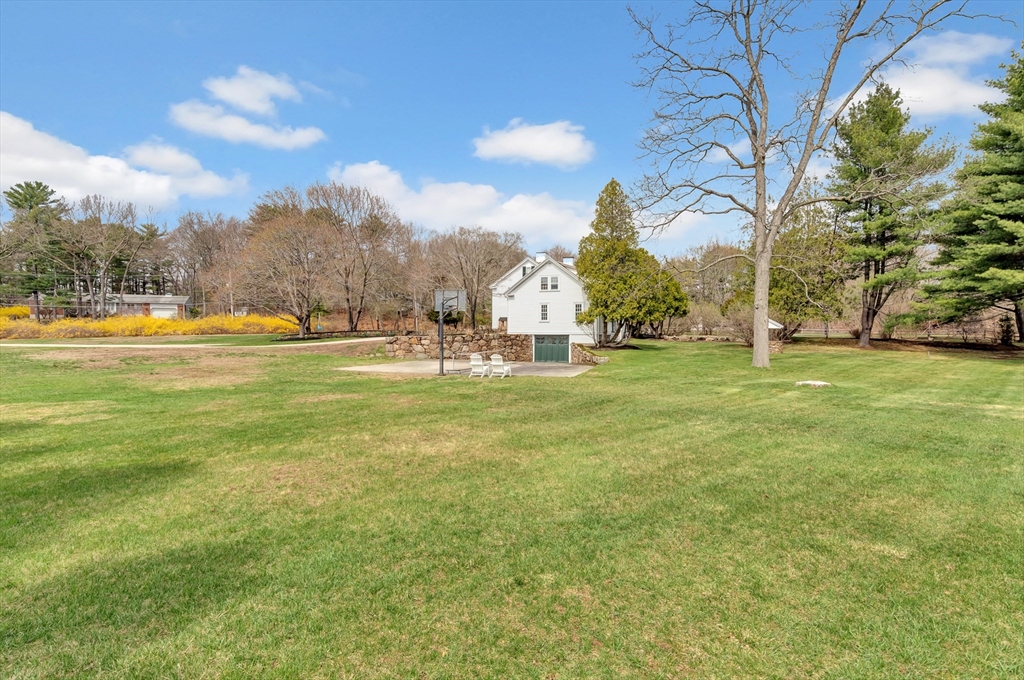 505 Essex Street Hamilton, MA 01982 - Photo 33 of 37 a big yard with lots of tress in it