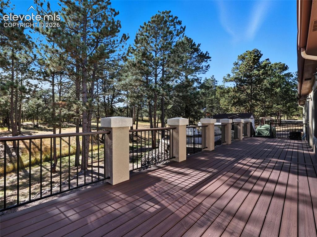12855 Murphy Road Elbert, CO 80106 - Photo 37 of 50 a view of a deck with wooden floor and fence next to a yard